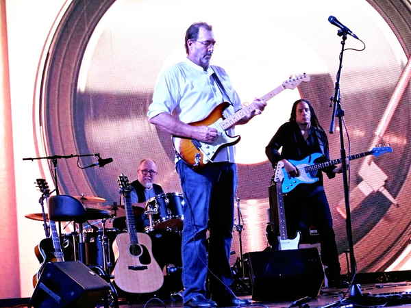 Five people performing on stage in a tribute band for Eric Clapton | Altus Entertainment